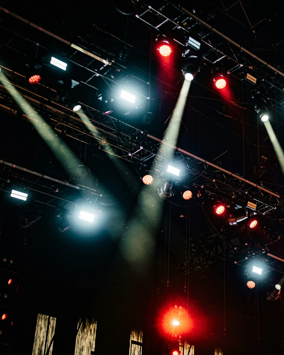 Lighting rig and trusses from below during a live performance.